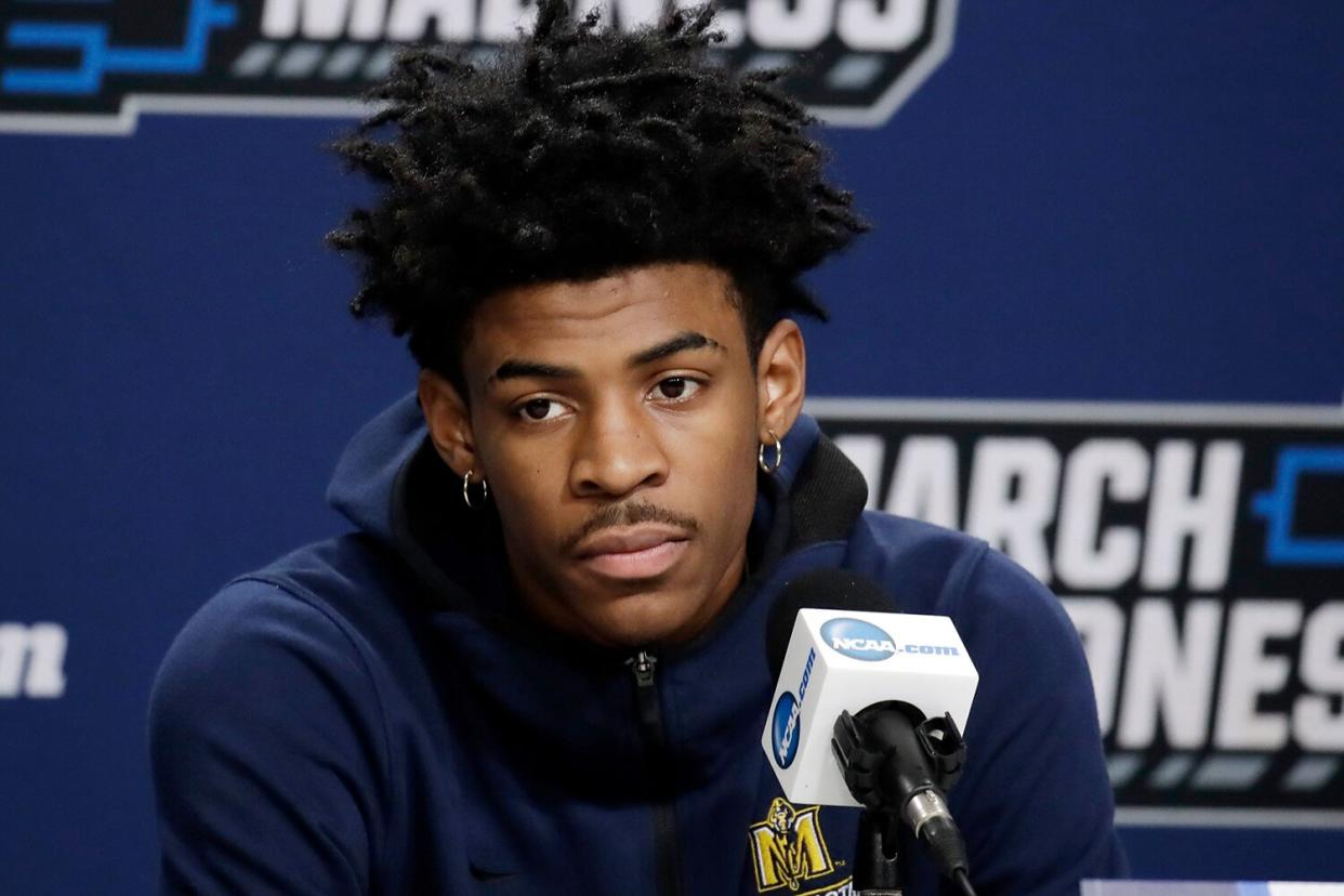 Ja Morant listens to a question during a news conference