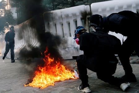 An anti-government protester prepares to throw a Molotov cocktail during a demonstration near Central Government Complex, in Hong Kong