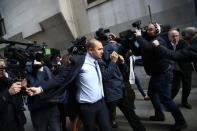 British journalist Mazher Mahmood covers his face with his coat as he leaves the Old Bailey Courthouse in London, Britain October 5, 2016. REUTERS/Neil Hall