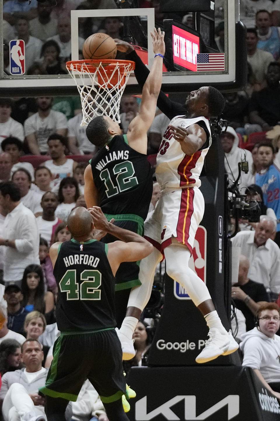 Miami Heat center Bam Adebayo (13) dunks the ball over Boston Celtics forward Grant Williams (12) during the second half of Game 3 of the NBA basketball playoffs Eastern Conference finals, Sunday, May 21, 2023, in Miami. (AP Photo/Wilfredo Lee)