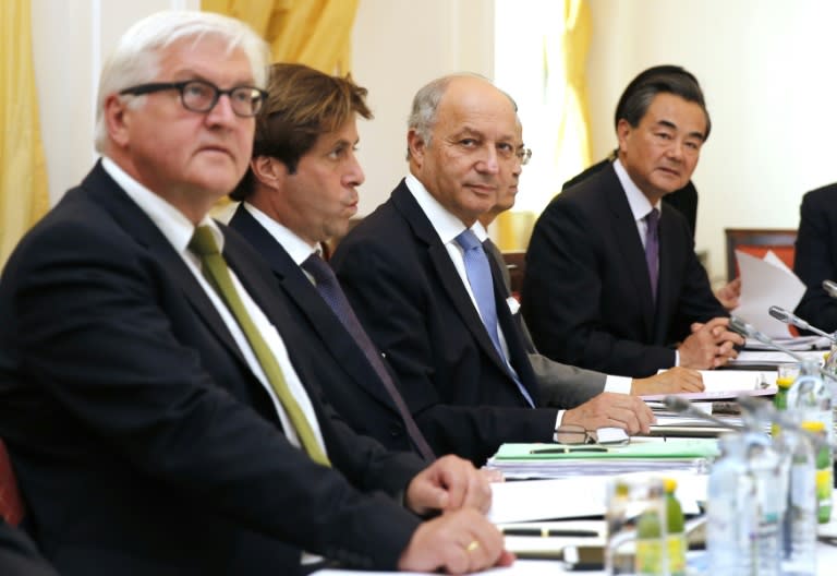 German FM Frank-Walter Steinmeier (L), French FM Laurent Fabius (3-L) and Chinese FM Wang Yi (R) sit around the table at Iran nuclear talks in Vienna on July 6, 2015