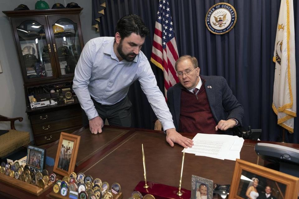 Rep. Jim Langevin, D-R.I., right, works in his office with his chief of staff, Mike DeAngelis, Friday, March 25, 2022, in Warwick, R.I. After the Capitol riot, Langevin said he thought briefly that the foolishness and recklessness of dividing the country would finally stop. That didn’t happen, and the Rhode Island Democrat says it’s one reason why he’s leaving Congress. (AP Photo/Michael Dwyer)