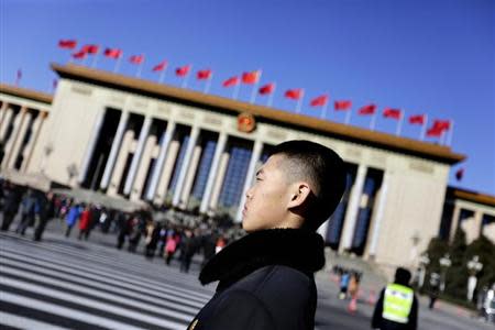 A soldier in plain clothes from the Chinese People's Liberation Army (PLA) stands guard in front of the Great Hall of the People, the venue of the annual session of China's parliament, the National People's Congress (NPC), in Beijing March 4, 2014. REUTERS/Jason Lee