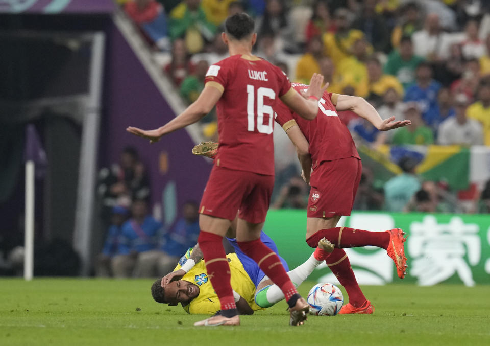 Brazil's Neymar, bottom, fights for the ball with Serbia's Strahinja Pavlovic during the World Cup group G soccer match between Brazil and Serbia, at the Lusail Stadium in Lusail, Qatar, Thursday, Nov. 24, 2022. (AP Photo/Themba Hadebe)