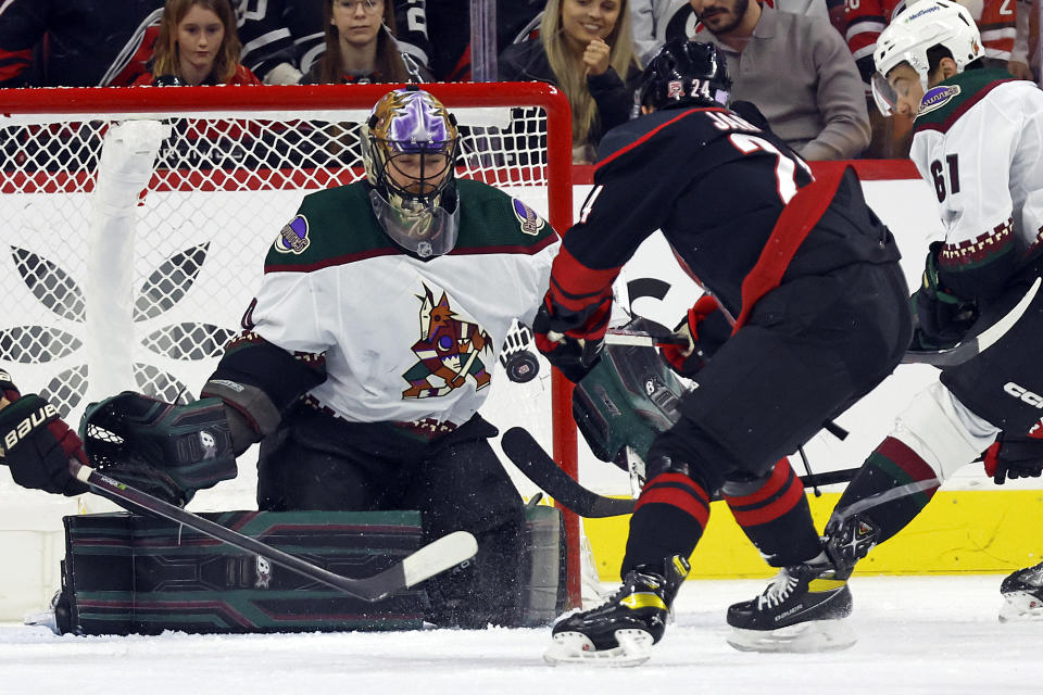 Carolina Hurricanes' Seth Jarvis (24) has his shot bounce off Arizona Coyotes goaltender Karel Vejmelka (70) during the first period of an NHL hockey game in Raleigh, N.C., Wednesday, Nov. 23, 2022. (AP Photo/Karl B DeBlaker)