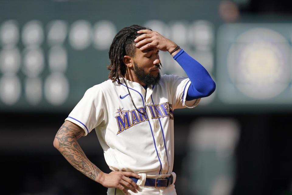 Seattle Mariners' J.P. Crawford stands on the field after he flew out to end the seventh inning of a baseball game against the Arizona Diamondbacks, Sunday, Sept. 12, 2021, in Seattle. (AP Photo/Elaine Thompson)