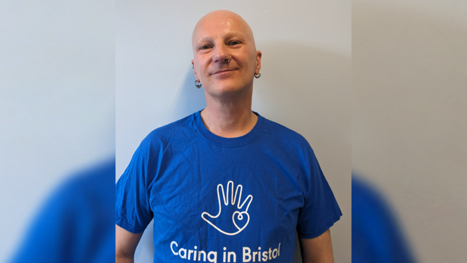 A man wearing a Caring in Bristol charity t-shirt