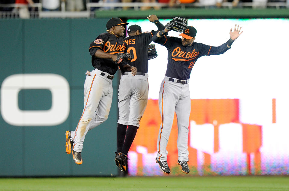 WASHINGTON, DC - MAY 18: Xavier Avery #13, Adam Jones #10 and Nick Markakis #21 of the Baltimore Orioles celebrate after a 2-1 victory against the Washington Nationals at Nationals Park on May 18, 2012 in Washington, DC. (Photo by Greg Fiume/Getty Images)