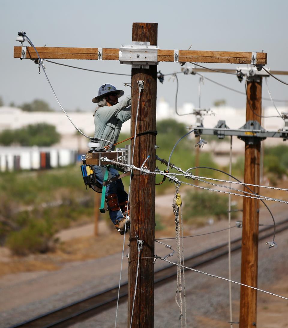 SRP line worker at the Loop 202 South Mountain Freeway construction site near 59th Ave. south of Van Buren Street on July 24, 2018, in Phoenix, Ariz.