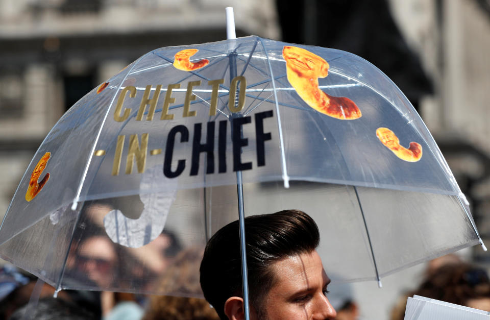 A protester carries an umbrella during an anti-Trump demonstration.