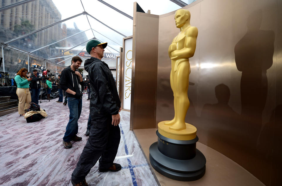 Preparations continue on the red carpet during rainy weather for the 86th Academy Awards in Los Angeles, Friday, Feb. 28, 2014. The Academy Awards will be held at the Dolby Theatre on Sunday, March 2. (Photo by Jordan Strauss/Invision/AP)