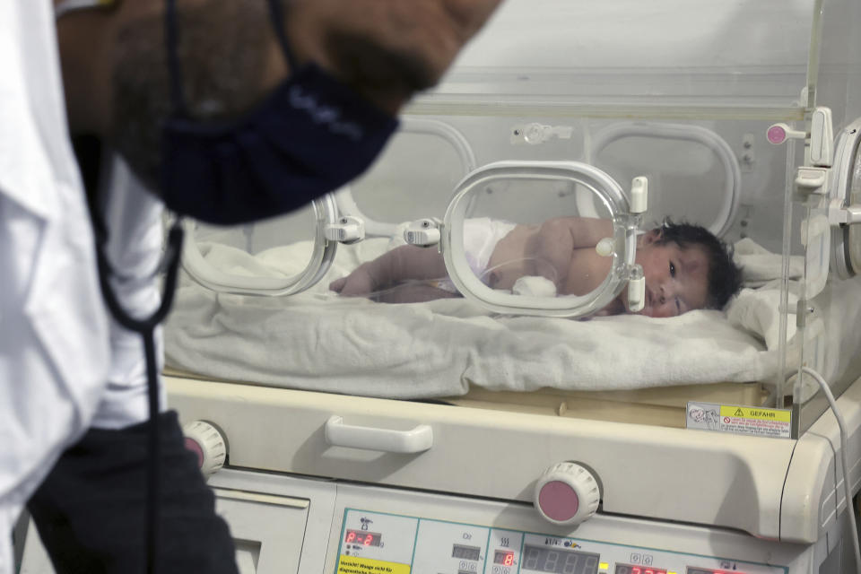 A baby girl who was born under the rubble caused by an earthquake that hit Syria and Turkey receives treatment inside an incubator at a children's hospital in the town of Afrin, Aleppo province, Syria, Tuesday, Feb. 7, 2023. Residents in a northwest Syrian town discovered a crying infant whose mother gave birth to her while buried underneath the rubble of a five-story apartment building leveled by this week's devastating earthquake, relatives and a doctor said Tuesday. (AP Photo/Ghaith Alsayed)