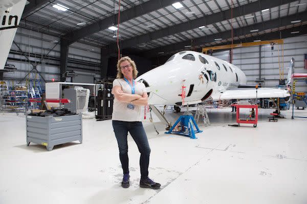 Australian Vivien Cornish, shown here during a visit to Virgin Galactic's Mojave headquarters, is among 600 space fans who have paid $250,000 for a ride on SpaceShipTwo, shown behind Cornish.