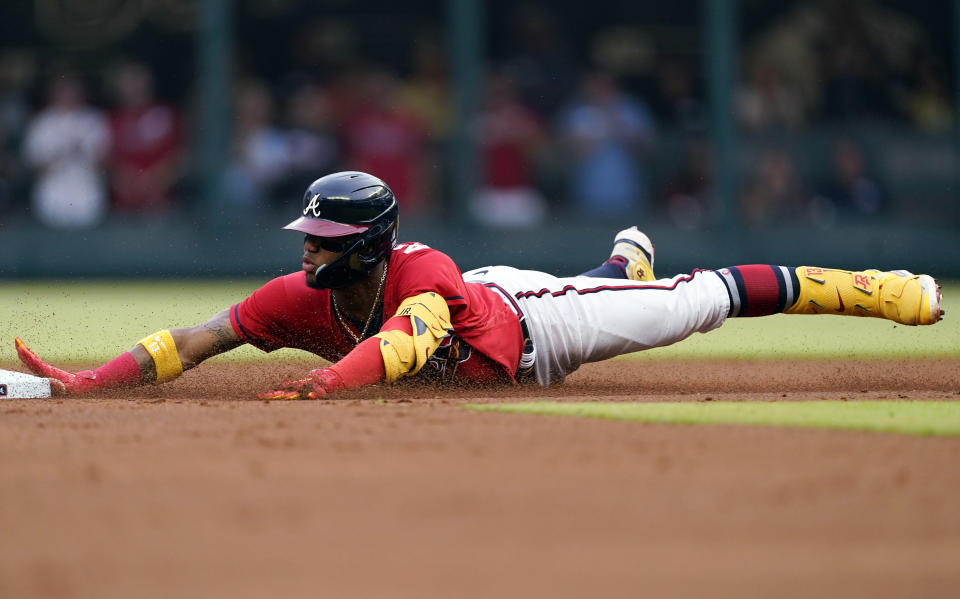 Atlanta Braves' Ronald Acuna Jr. slides into second base with a double in the first inning of the team's baseball game against the Pittsburgh Pirates on Friday, June 10, 2022, in Atlanta. (AP Photo/John Bazemore)