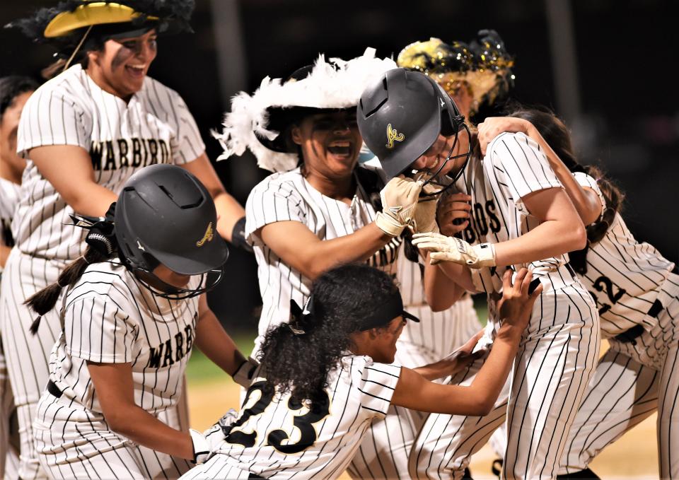 Abilene High players swarm Kinzley Cantu, near right, after the freshman drove in the game-winning run with a sacrifice fly in the ninth inning. The Lady Eagles beat Stamford 1-0 on Tuesday, March 1, 2022, despite not getting a hit and striking out 22 times against University of Texas signee Citlaly Gutierrez at the AHS softball field.