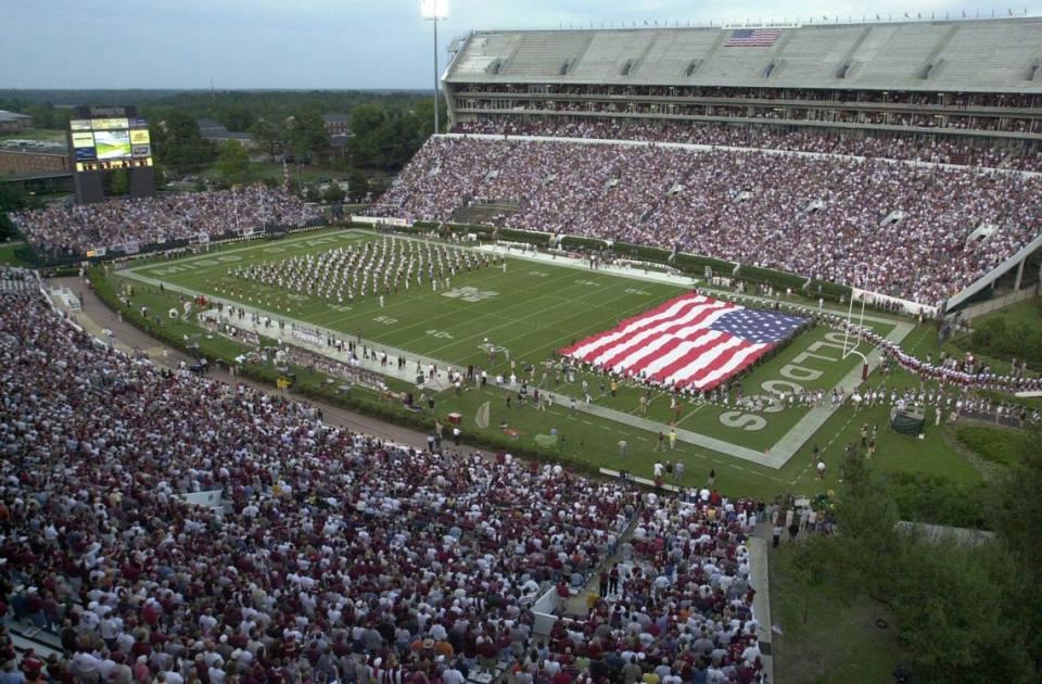 Sept. 20, 2001: South Carolina and Mississippi State football players help hold a huge American flag during the National Anthem.