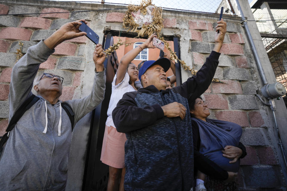 Neighbors takes photos of ruling party presidential candidate Claudia Sheinbaum arriving to vote during general elections in Mexico City, Sunday, June 2, 2024. (AP Photo/Eduardo Verdugo)
