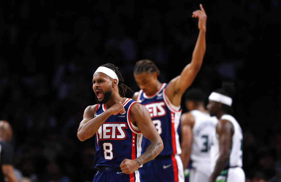 Brooklyn Nets guard Patty Mills (8) reacts after making a 3-point shot against the Milwaukee Bucks during the first half of an NBA basketball game Thursday, March 31, 2022, in New York. (AP Photo/Noah K. Murray)