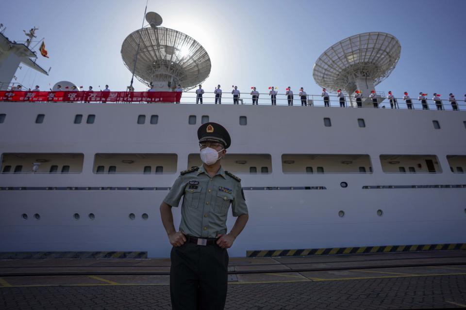 A Chinese military officer stands by the Chinese scientific research ship Yuan Wang 5 after it arrived at Hambantota International Port in Hambantota, Sri Lanka, Tuesday, Aug. 16, 2022. The ship was originally set to arrive Aug. 11 but the port call was deferred due to apparent security concerns raised by India. (AP Photo/Eranga Jayawardena)