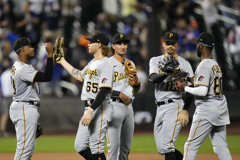 Pittsburgh Pirates' Jack Suwinski (65), Bryan Reynolds (10) and Liover Peguero (60) celebrate with teammates after a baseball game against the New York Mets on Tuesday, Aug. 15, 2023, in New York. (AP Photo/Frank Franklin II)