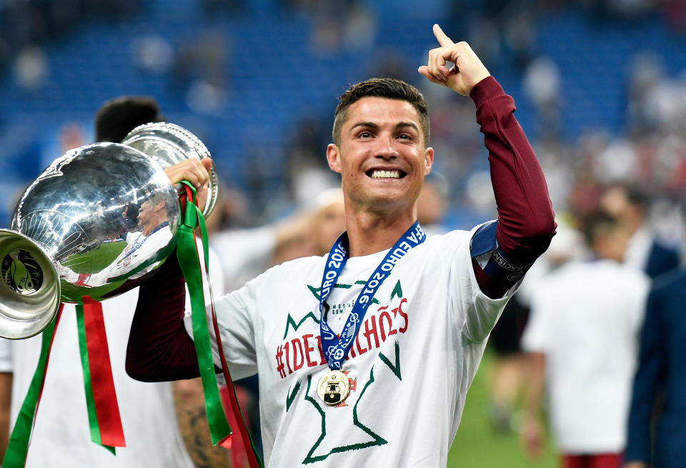 Portugal's Cristiano Ronaldo holds the trophy  after winning the Euro 2016 final soccer match between Portugal and France at the Stade de France in Saint-Denis, north of Paris, Sunday, July 10, 2016. Portugal won 1-0. (AP Photo/Martin Meissner)