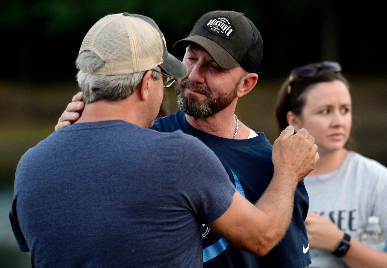 Franklin Police Lt. Scott Legieza, center, father of Brentwood Police Officer Destin Legieza, is consoled by a friend before a candlelight vigil for his son at the Fellowship Bible Church on Friday, June 19, 2020, in Brentwood, Tenn. Legieza was killed in a head-on collision on Franklin Road while heading back to the precinct at the end of his shift Thursday morning.