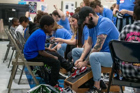 More than 150 Genesco employees fitted approximately 250 students at Ida B. Wells Elementary School in Nashville today with new shoes from Nashville-based footwear focused retailer in celebration of its 100th anniversary. Genesco partnered with Nashville-based, global nonprofit Soles4Souls, to surprise the elementary school students with brand new shoes, socks and snacks before hitting the red carpet to snap a photo. In its 35th year, Cold Feet, Warm Shoes recreates a real-life, in-store experience, complete with a mock shoe store, customized shoe fitting where employee volunteers measure each student’s foot and fit them with a new pair of shoes and socks. (Photo: Business Wire)