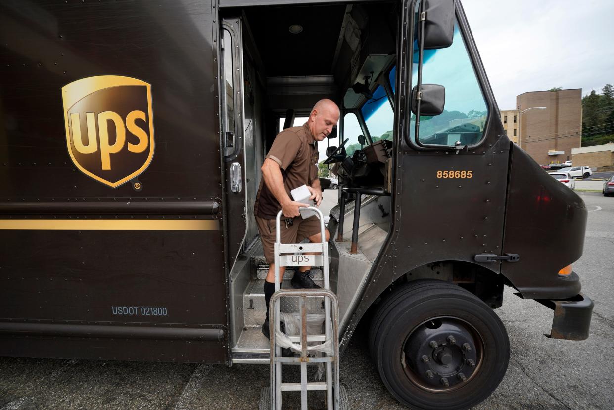 UPS driver Joe Speeler makes a delivery at the Leanon Shops in Mount Lebanon, Pa., on Tuesday, Sept. 21, 2021. The Teamsters union and the shipping giant tentatively agreed on a contract in 2023 that would pay the average, full-time UPS driver $170,000 per year, UPS CEO Carol Tomé said during an Aug. 8 earnings call.