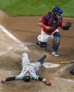 Chicago White Sox's Billy Hamilton, bottom, is tagged out by Minnesota Twins catcher Willians Astudillo while trying to stretch a triple in the fifth inning of a baseball game, Monday, May 17, 2021, in Minneapolis. (AP Photo/Jim Mone)