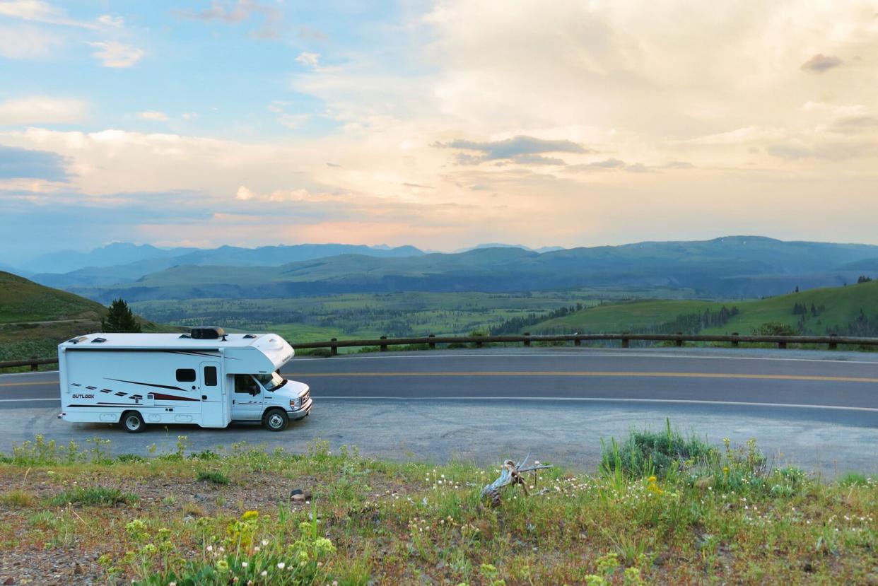 White rental RV parked on the side of a windy road with incredible views in Yellowstone National Park