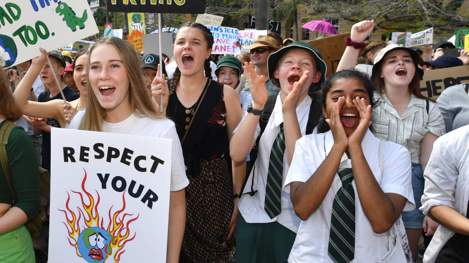 Climate change protestors are seen in Queens Gardens during the Global Strike 4 Climate rally in Brisbane, Friday, September 20, 2019. The Global Strike 4 Climate will take place in 110 towns and cities across Australia, with organisers demanding government and business commit to a target of net zero carbon emissions by 2030. (AAP Image/Darren England) NO ARCHIVING