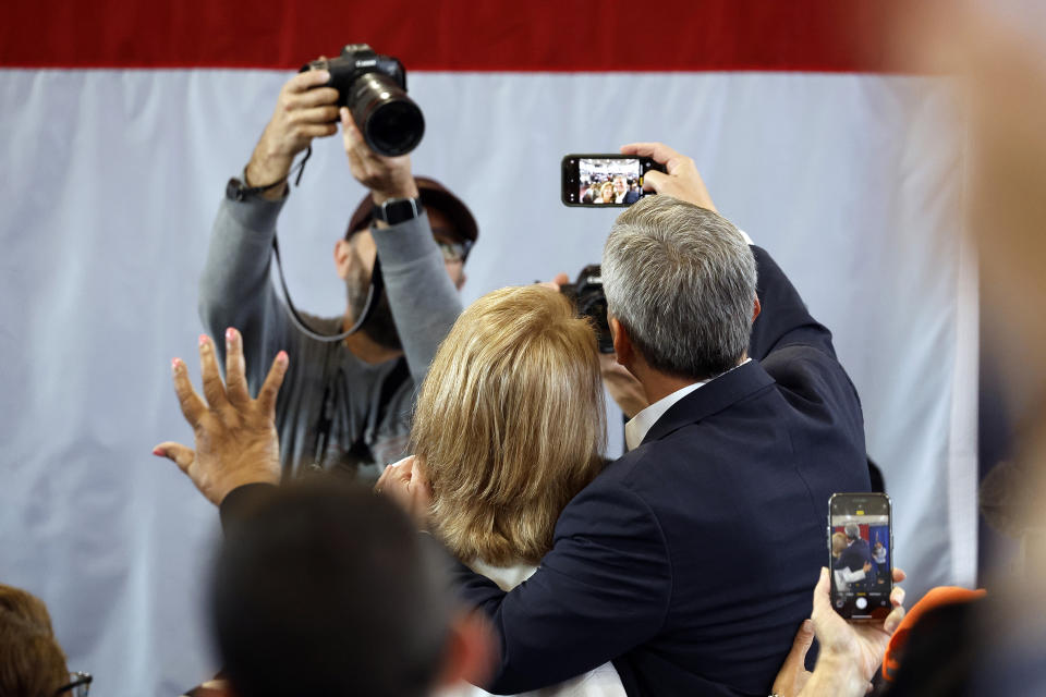 Democratic North Carolina gubernatorial candidate Josh Stein, right, takes a selfie with his wife Anna, left, following a rally at Shaw University in Raleigh, N.C., Tuesday, Oct. 10, 2023. (AP Photo/Karl B DeBlaker)