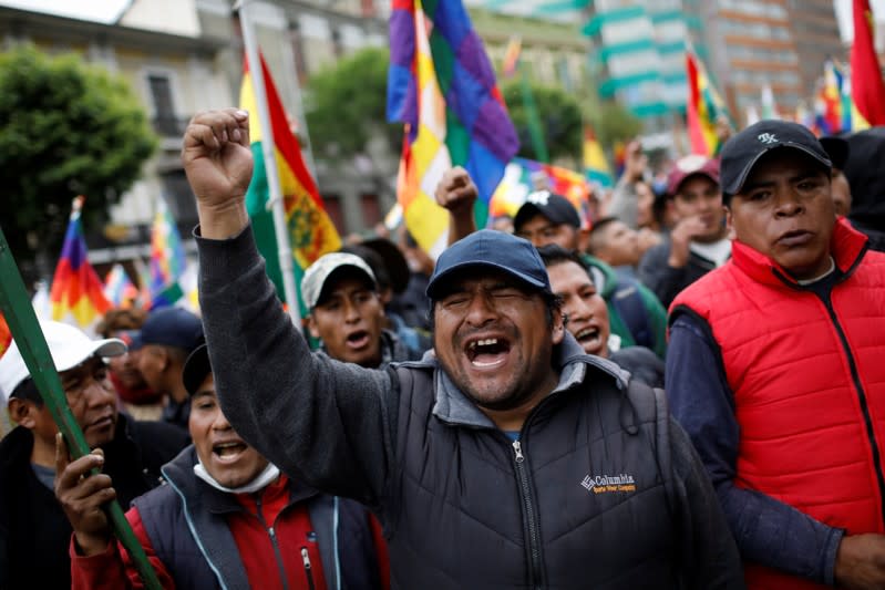 Supporters of Bolivia's ousted President Evo Morales hold Wiphala and Bolivian flags as they take part in a protest, in La Paz