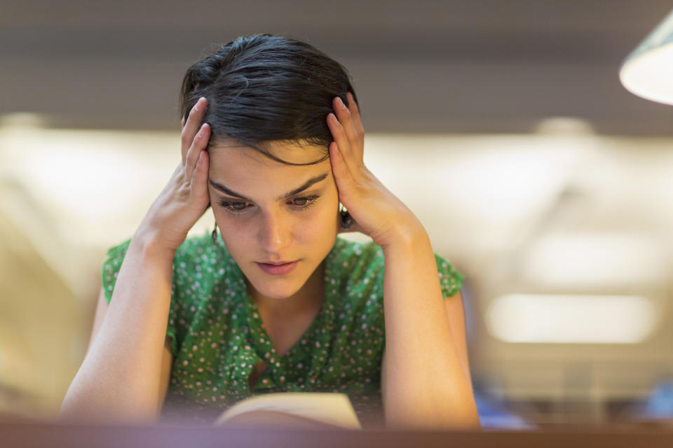 Mixed race student studying in library