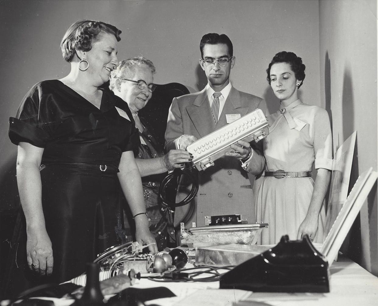 Looking over some of the new dial telephone equipment in 1956. (Left to right) Margaret Smith Cousino, Katie Smith, Norman Smith, and Betty (Chinavare) Smith.
