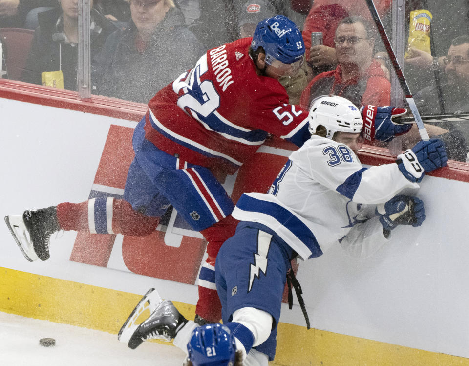 Montreal Canadiens' Justin Barron (52) and Tampa Bay Lightning's Brandon Hagel (38) battle for the puck during the first period of an NHL hockey game, Tuesday, Nov. 7, 2023 in Montreal. (Christinne Muschi/The Canadian Press)