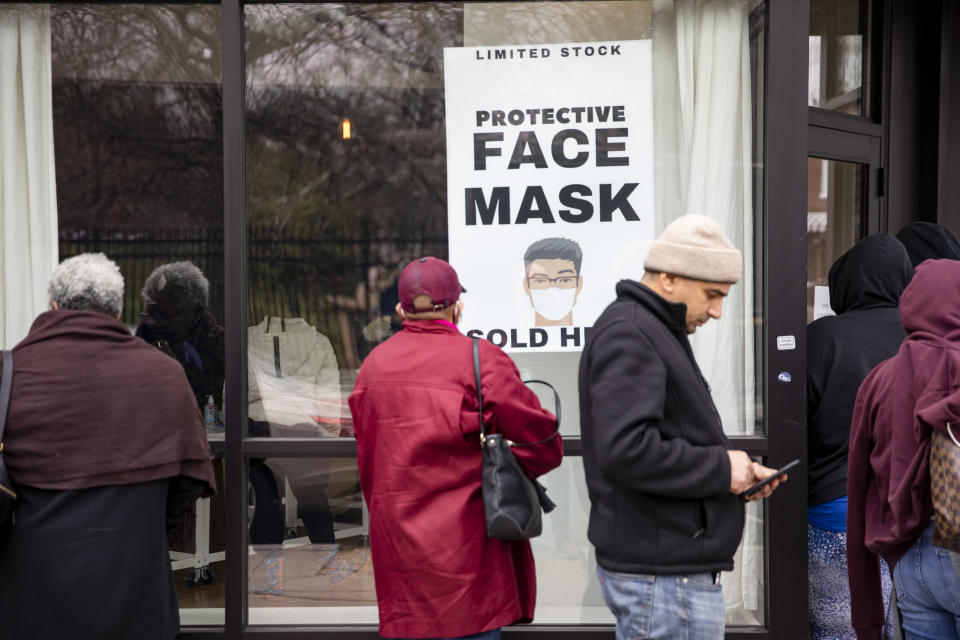 Customers line up outside of a coronavirus pop-up store