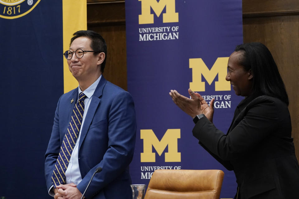 University of Michigan Board of Regents member Katherine White claps as Santa Ono is introduced as the new president of the University of Michigan, Wednesday, July 13, 2022, in Ann Arbor, Mich. Ono becomes UM's 15th president and its first minority and Asian chief executive — the son of Japanese immigrants who came to the United States after World War II. The 59-year-old Ono has led the University of British Columbia for nearly six years after guiding the University of Cincinnati for four years. (AP Photo/Carlos Osorio)