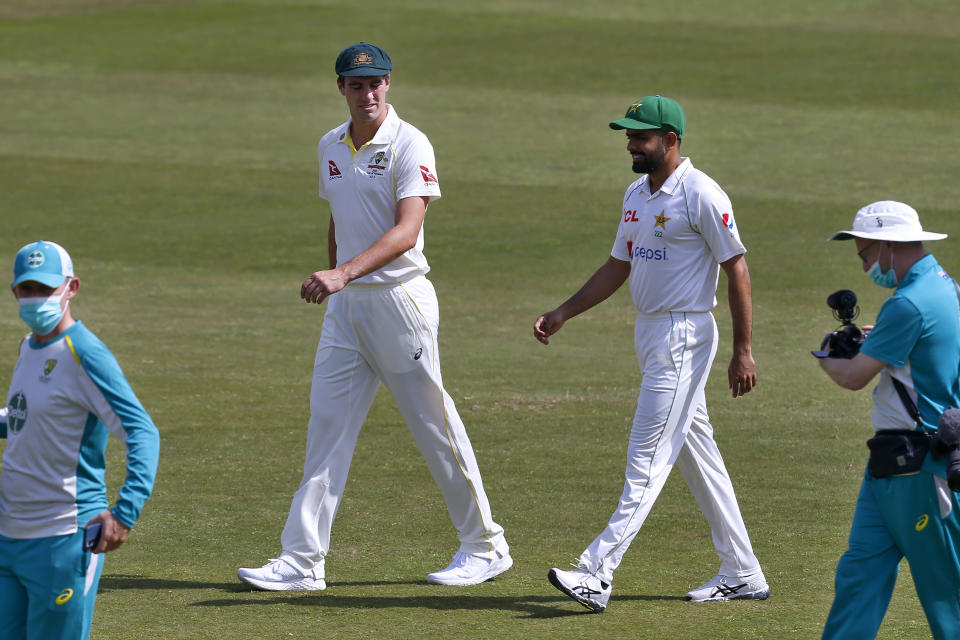 Pakistan's skipper Babar Azam, second right, and his Australian counterpart Pat Cummins, second left, arrive for a photo with the test series trophy at the Pindi Stadium in Rawalpindi, Pakistan, Wednesday, March 2, 2022. Pakistan and Australia cricket teams will play first test match on March 4. (AP Photo/Anjum Naveed)