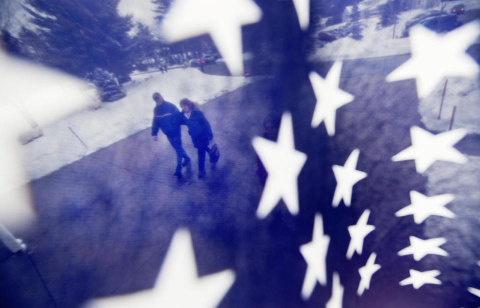 A couple walk to a polling place in Nashua