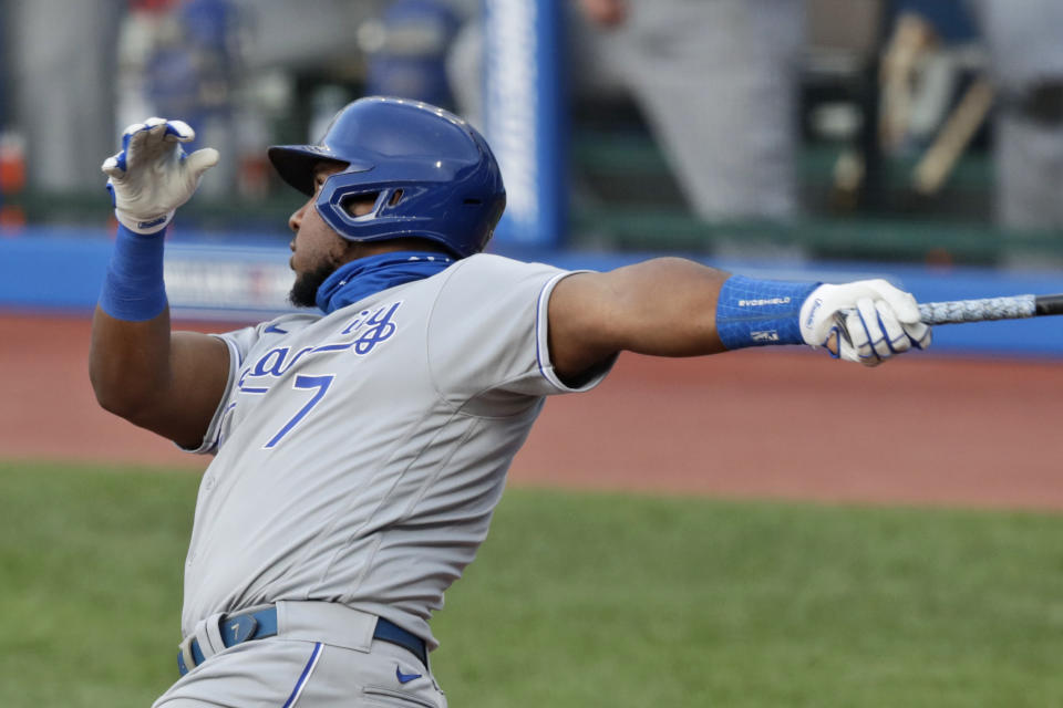 Kansas City Royals' Maikel Franco watches his sacrifice fly in the 10th inning of a baseball game against the Cleveland Indians, Saturday, July 25, 2020, in Cleveland. Royals' Brett Phillips scored on the play. (AP Photo/Tony Dejak)
