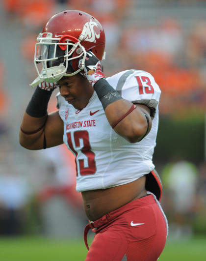 Washington State Cougars linebacker Darryl Monroe (13) puts on his helmet prior to the game against the Auburn Tigers. (Shanna Lockwood-USA TODAY Sports)