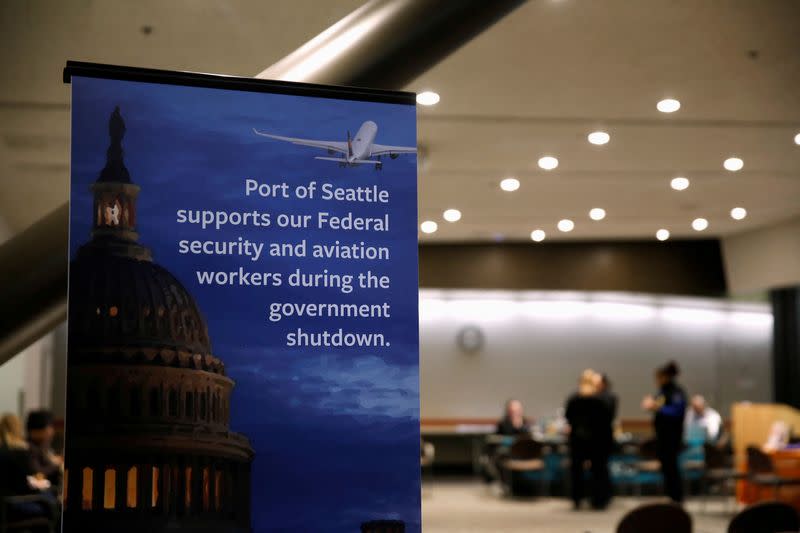 FILE PHOTO: A Port of Seattle sign referencing the shutdown sits outside a resource fair for employees affected by the partial federal government shutdown at Seattle-Tacoma International Airport in Seattle