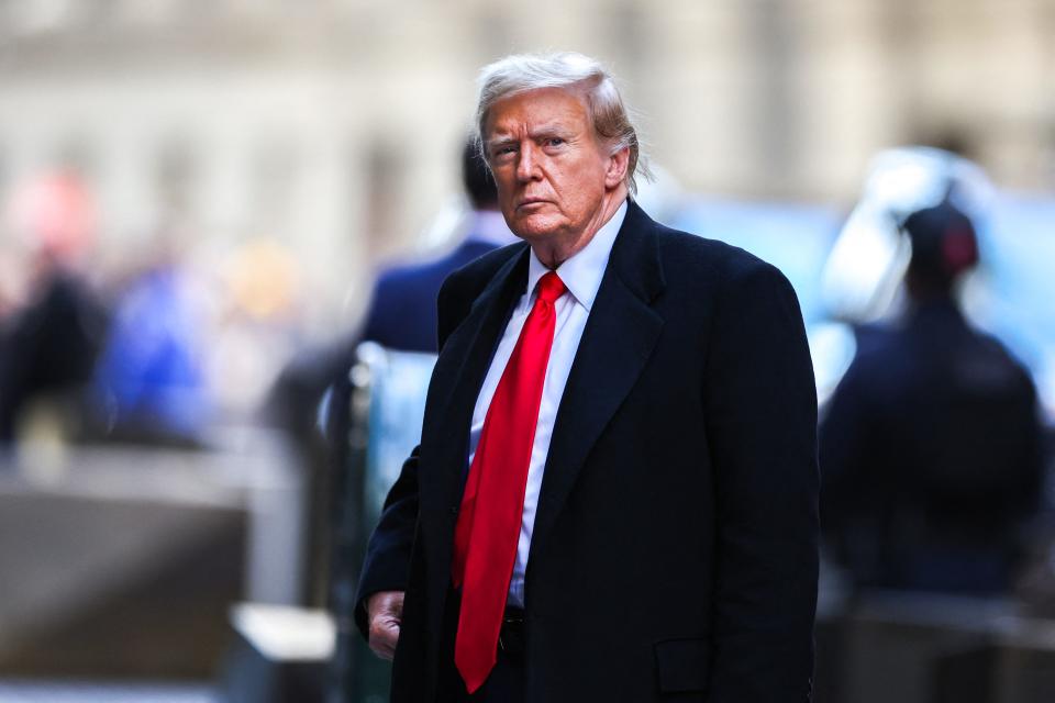 Former President Donald Trump arrives at 40 Wall Street after his court hearing to determine the date of his trial for allegedly covering up hush money payments linked to extramarital affairs in New York City on March 25, 2024.