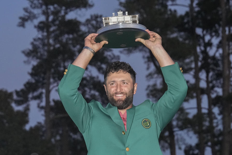 FILE - FILE - Jon Rahm, of Spain, holds up the trophy after winning the Masters golf tournament at Augusta National Golf Club on Sunday, April 9, 2023, in Augusta, Ga. Rahm is expected to compete in the PGA Championship next week at Oak Hill Country Club in Pittsford, N.Y. Rahm has been saying that he plays golf for history and for legacy, not for money. And now he's playing for the Saudi-funded LIV Golf League in a shocking departure from the PGA Tour.(AP Photo/David J. Phillip, File)