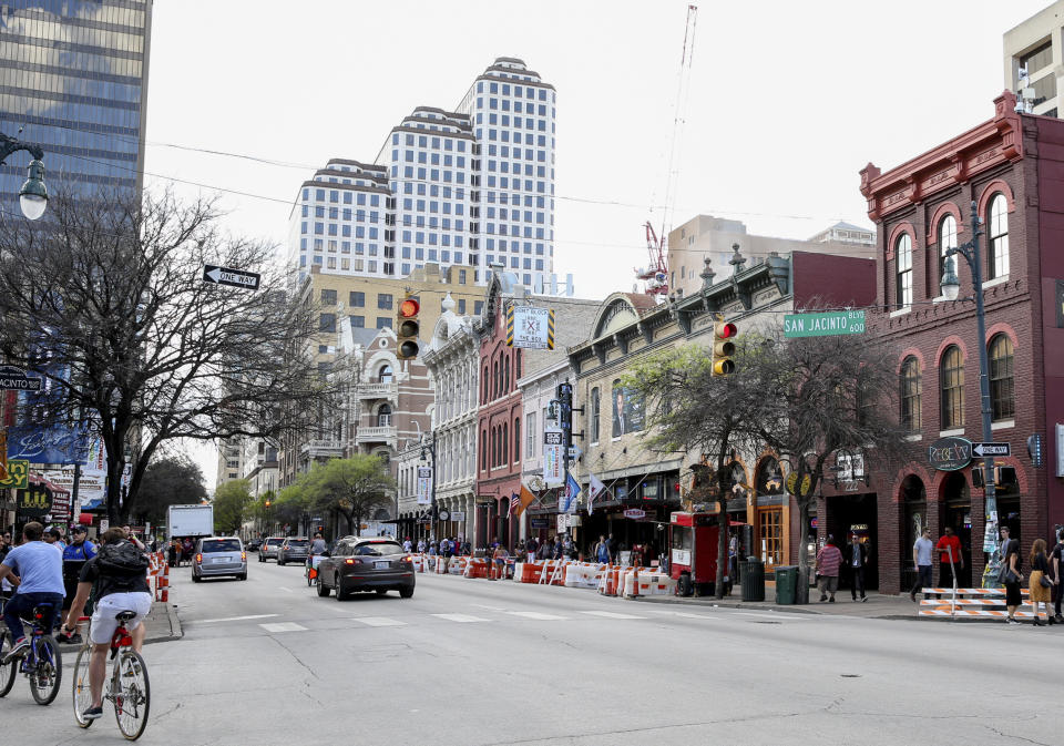 FILE - This March 12, 2016 file photo shows a general view of Sixth Street during South By Southwest in Austin, Texas. Austin city officials have canceled the South by Southwest arts and technology festival. Mayor Steve Adler announced a local disaster as a precaution because of the threat of the novel coronavirus, effectively cancelling the annual event that had been scheduled for March 13-22. (Photo by Rich Fury/Invision/AP, File)