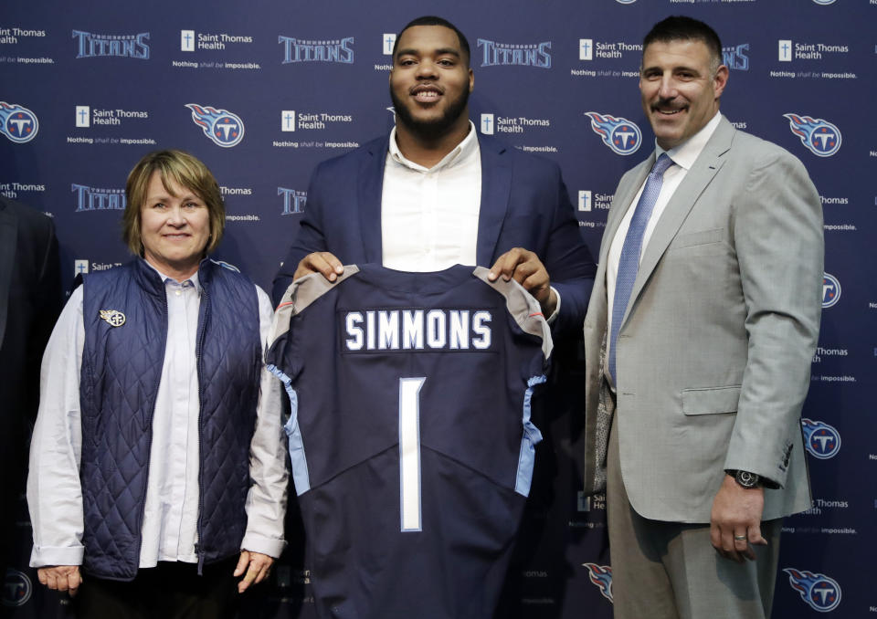 Mississippi State defensive tackle Jeffery Simmons, center, poses with Tennessee Titans owner Amy Adams Strunk, left, and head coach Mike Vrabel, right, during an NFL football news conference Friday, April 26, 2019, in Nashville, Tenn. Simmons was selected in the first round by the Titans. (AP Photo/Mark Humphrey)