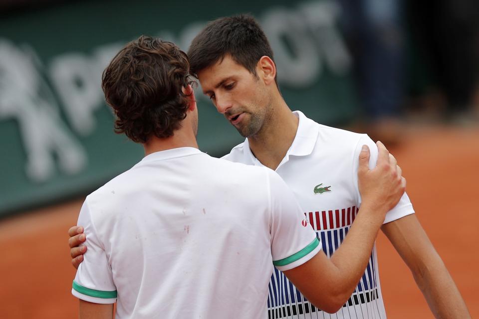 Austria's Dominic Thiem, left, meets Serbia's Novak Djokovic after their quarterfinal match the French Open tennis tournament at the Roland Garros stadium