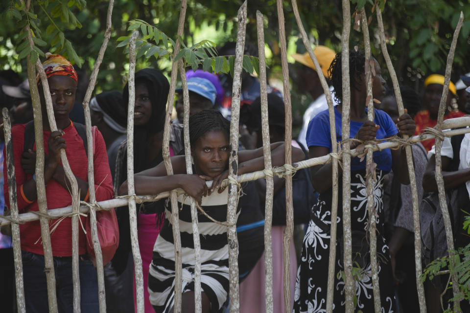 Residents wait in line during food distribution by the World Food Program in Jean-Rabel, Haiti, Wednesday, Aug. 3, 2022. (AP Photo/Odelyn Joseph)