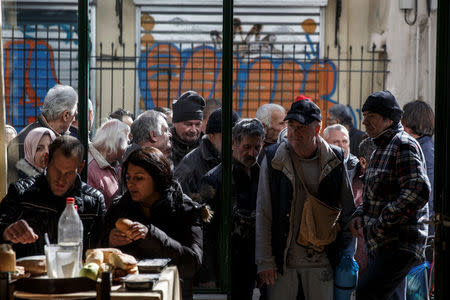 People line up as they wait to enter a soup kitchen run by the Orthodox church in Athens, Greece, February 15, 2017. REUTERS/Alkis Konstantinidis